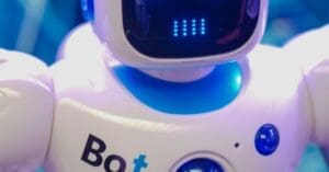 Close-up of a white humanoid robot toy with blue accents and a glowing blue LED face panel